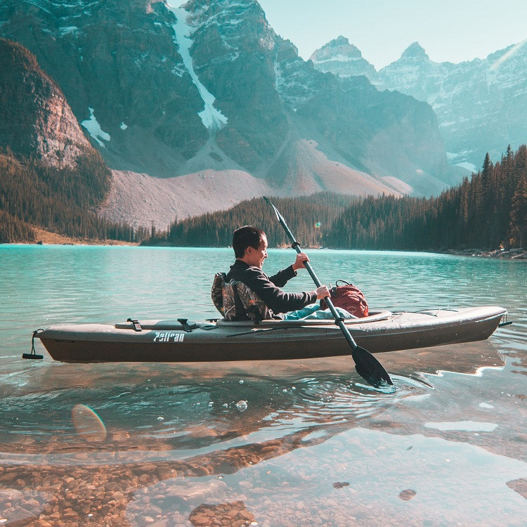 Kayaker wearing a breathable outdoor fabric jacket on the water
