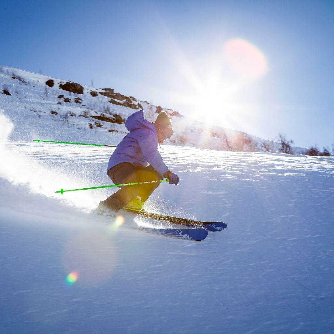 Person skiing in outdoor apparel made with functional fabric that is waterproof and breathable