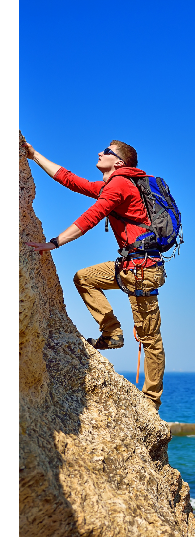 Person rock climbing outdoors wearing functional apparel