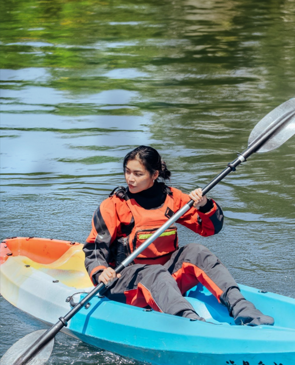 Person wearing a PORLITE&reg; dry suit made with breathable and waterproof fabric while kayaking