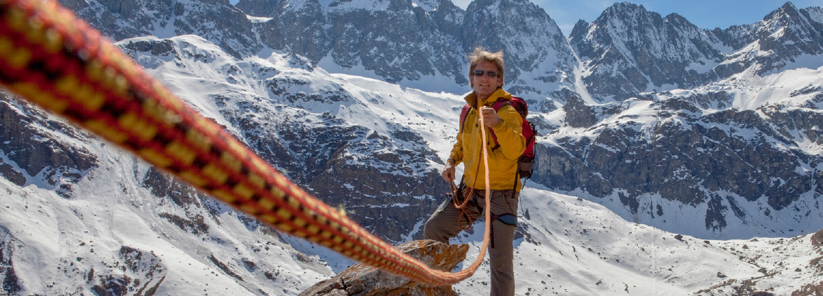 Mountaineer using a safety rope in a snowy alpine environment