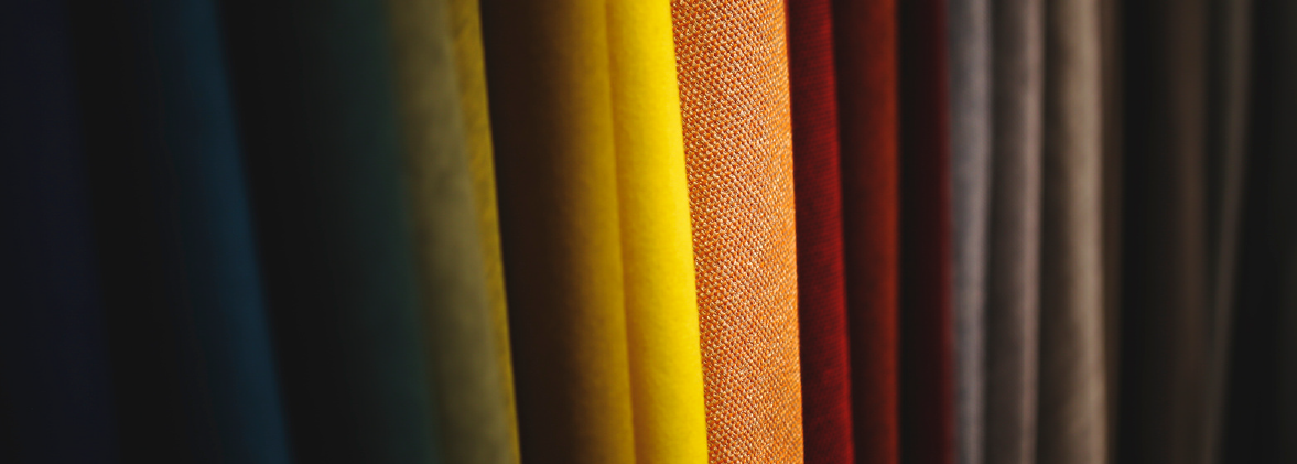 Row of draped multicolored performance fabrics from a Taiwan functional fabric manufacturer